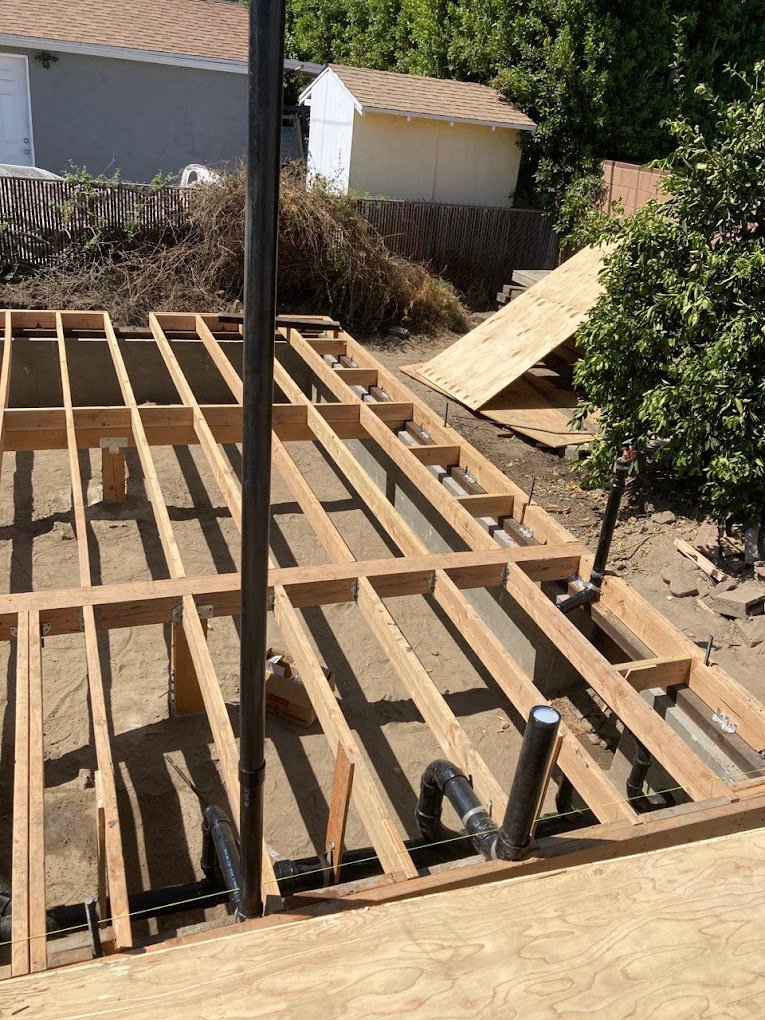 new construction plumbing between wood stud floor joists LA Wrench Plumbing San Fernando Valley