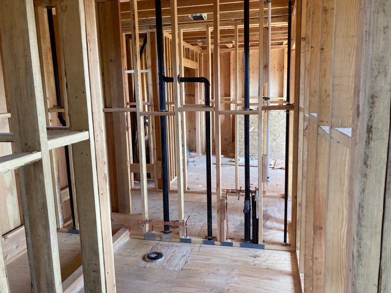 new construction plumbing inside wood stud framing