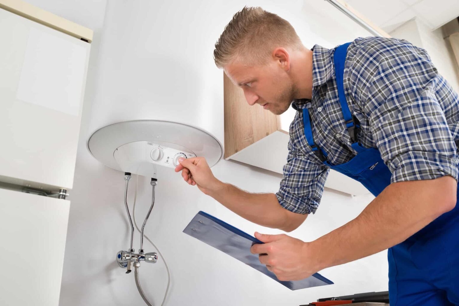 plumber adjusting water heater