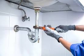 plumber tightening slip nut on under sink tailpiece LA Wrench Plumbing San Fernando Valley
